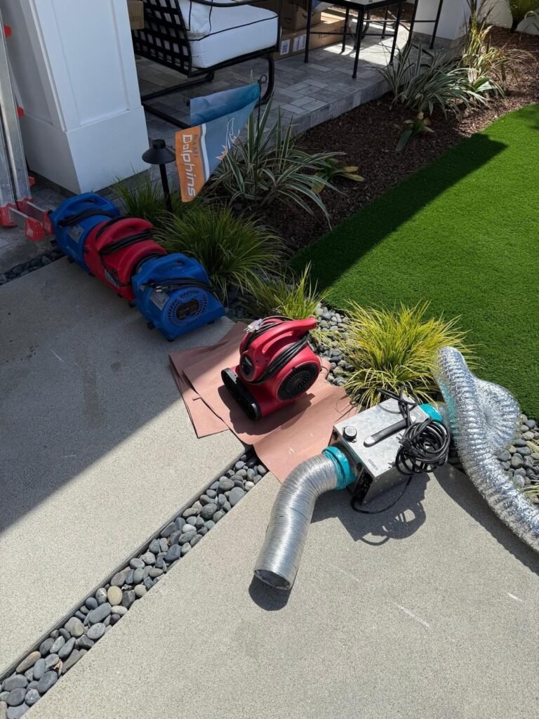 Drying equipment lined up on a patio with ducting running into the house in the East Bay